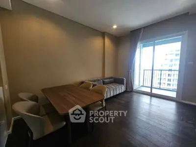 Modern living room with elegant dining set and balcony view
