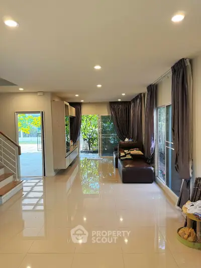 Spacious modern living room with large windows and elegant decor