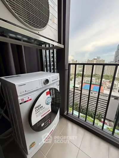 High-rise apartment balcony with washing machine and city view