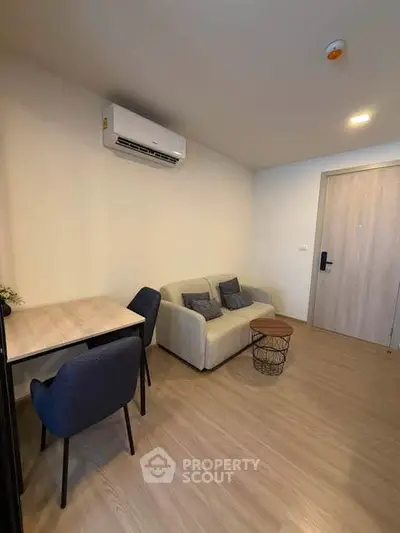 Modern living room with cozy sofa and dining area in stylish apartment.