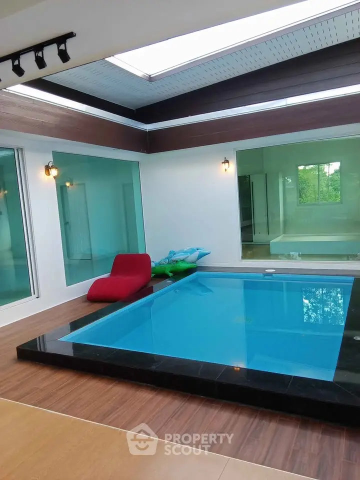 Luxurious indoor pool area with modern design and glass walls