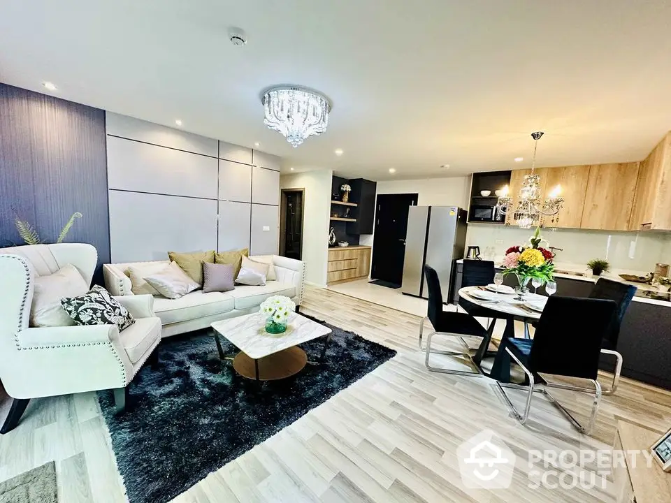 Luxurious open-plan living room with modern decor and elegant lighting in a stylish apartment.