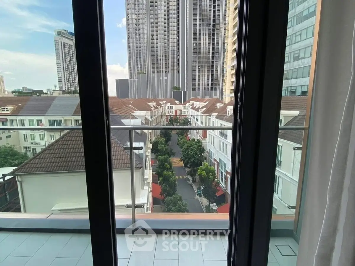 Stunning cityscape view from a modern apartment balcony, showcasing urban living at its finest.
