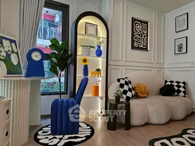 Stylish modern living room with unique furniture and artistic decor, featuring a cozy sofa and vibrant accents.