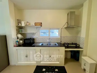 Charming kitchen with gas stove and modern appliances in cozy home