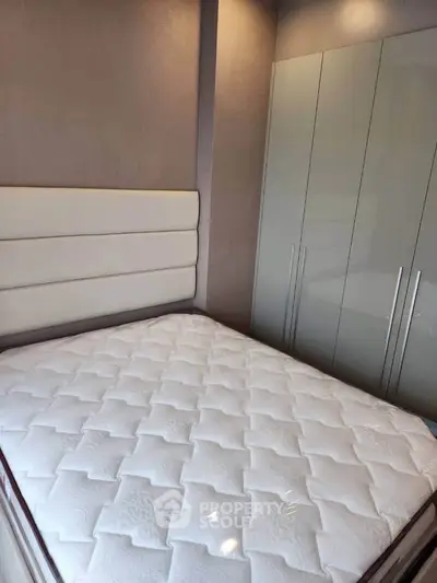 Modern bedroom with sleek wardrobe and comfortable mattress