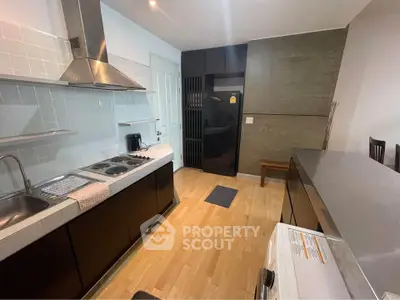 Modern kitchen with sleek appliances and open layout, featuring a gas stove and ample counter space.
