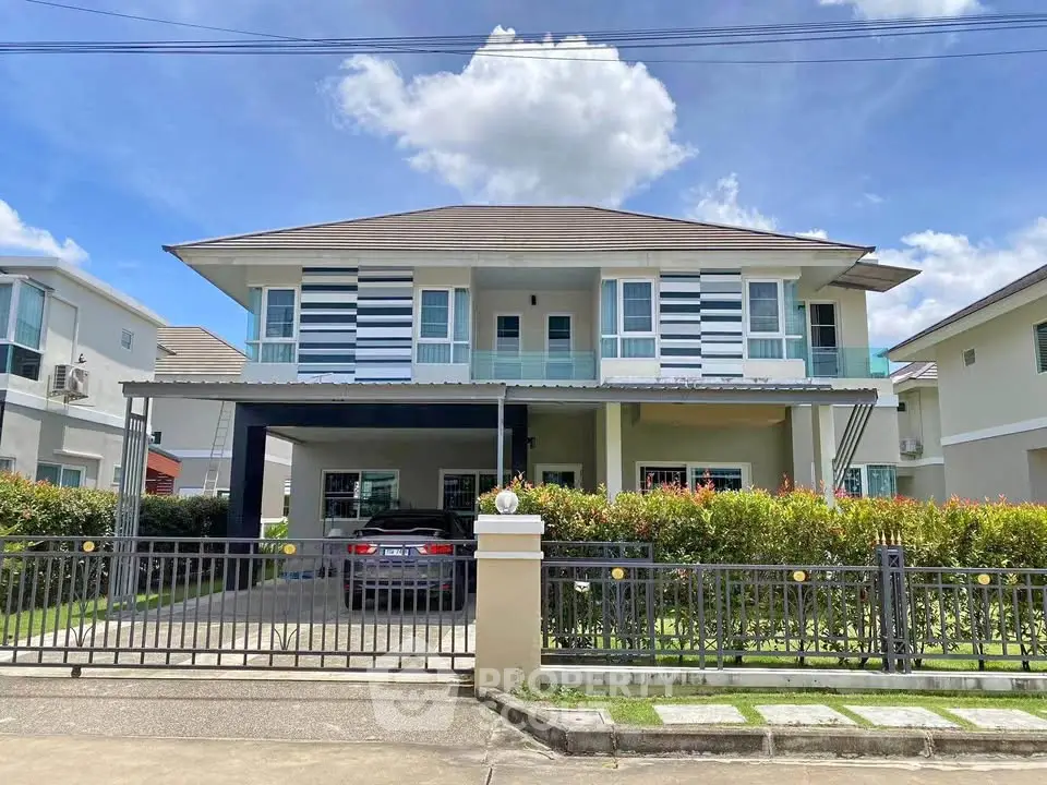 Stunning modern two-story house with a spacious driveway and lush greenery, perfect for family living.