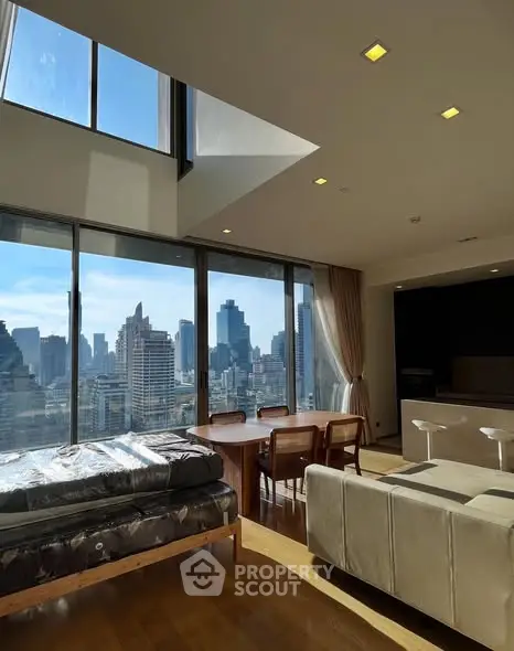 Luxurious high-rise living room with stunning city skyline view and modern furnishings.