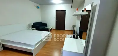 Modern studio apartment with cozy bed and sleek furniture, perfect for urban living.