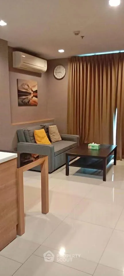Cozy living room with modern sofa, air conditioning, and elegant decor in a stylish apartment.