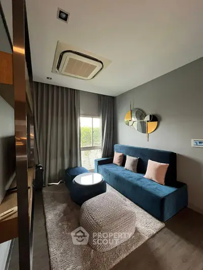 Stylish modern living room with plush blue sofa and chic decor