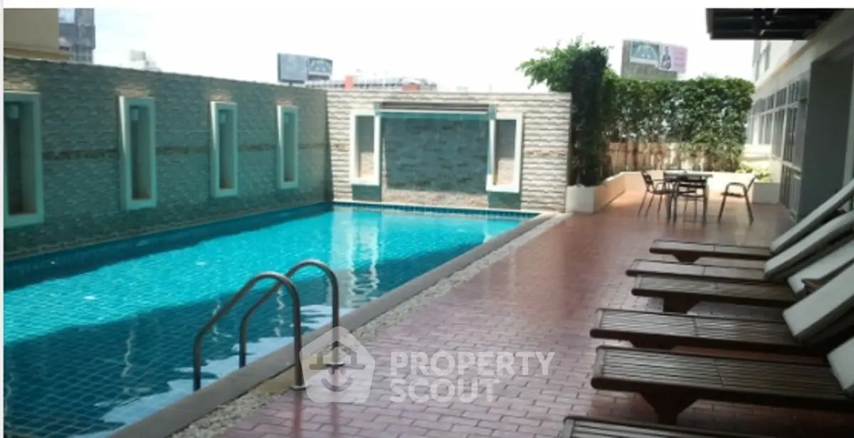 Luxurious poolside area with sun loungers and modern design, perfect for relaxation and leisure.