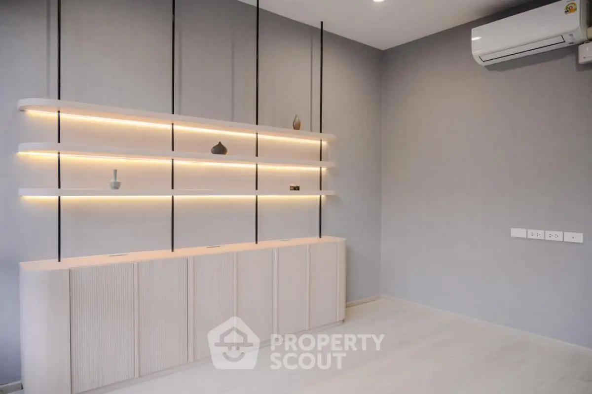 Modern minimalist living room with sleek wall shelves and air conditioning