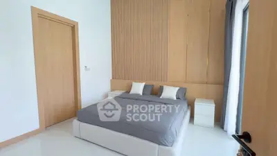 Modern bedroom with minimalist design and cozy bedding in a stylish apartment.