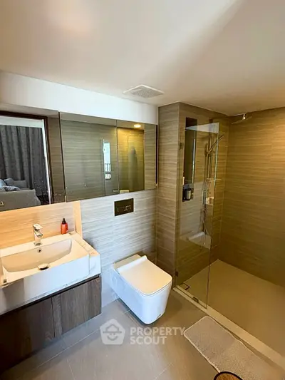 Modern bathroom with sleek design, glass shower, and elegant fixtures in a luxury apartment.