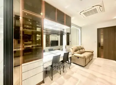 Modern living room with sleek design, featuring a cozy sofa and elegant dining area.