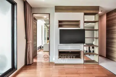 Modern living room with built-in TV unit and wooden flooring