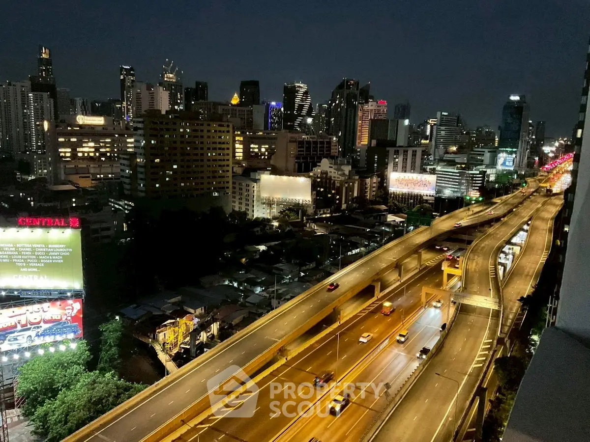 Stunning cityscape view with illuminated skyline and highway at night, perfect for urban living enthusiasts.