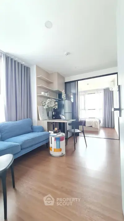Modern living room with blue sofa and stylish decor in bright apartment