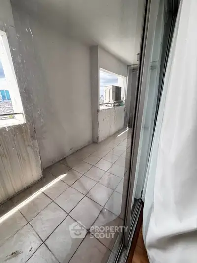 Spacious balcony with city view, perfect for relaxation and enjoying the skyline.