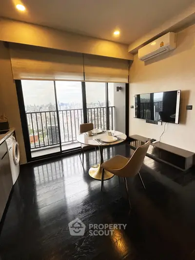 Modern living room with city view, featuring sleek furniture and wall-mounted TV, perfect for urban living.