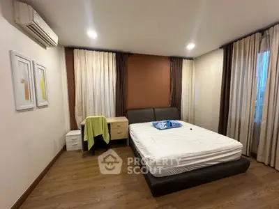 Spacious bedroom with modern decor and ample natural light