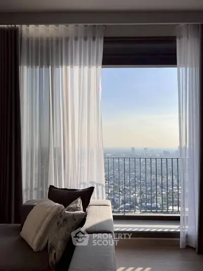 Stunning high-rise living room with panoramic city view and elegant decor.