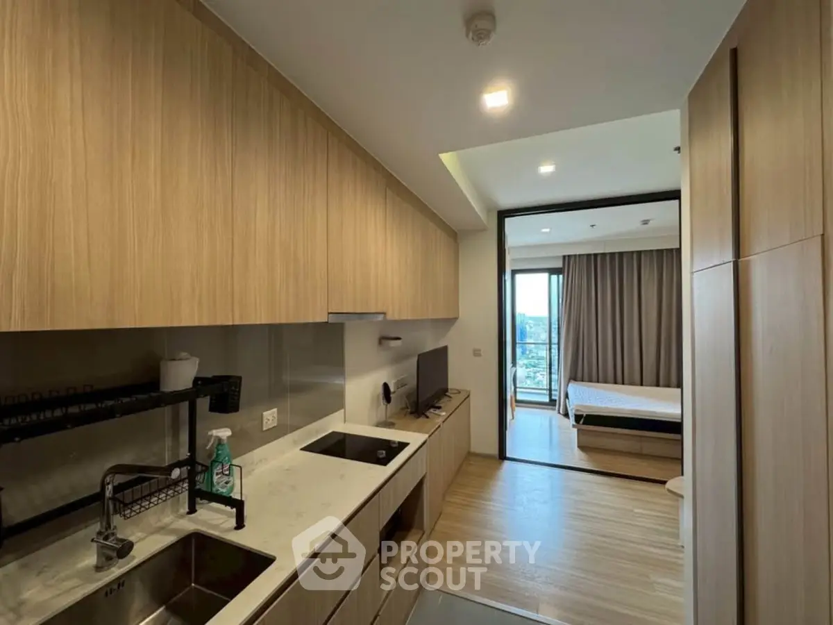 Modern apartment with open kitchen and cozy bedroom view