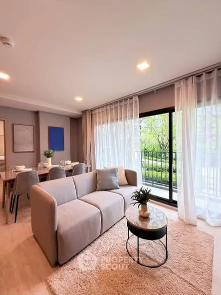 Spacious modern living room with large windows and elegant decor