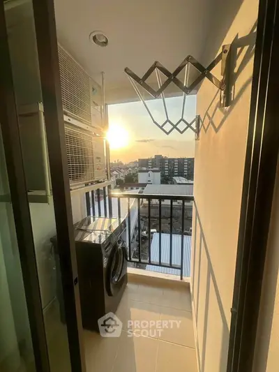 Charming balcony with laundry area and sunset view in modern apartment.