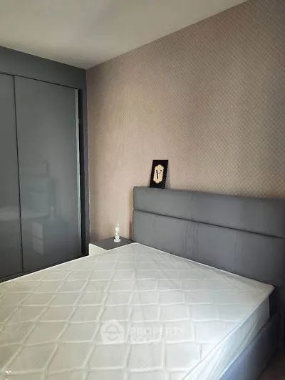 Modern bedroom with sleek gray wardrobe and stylish headboard