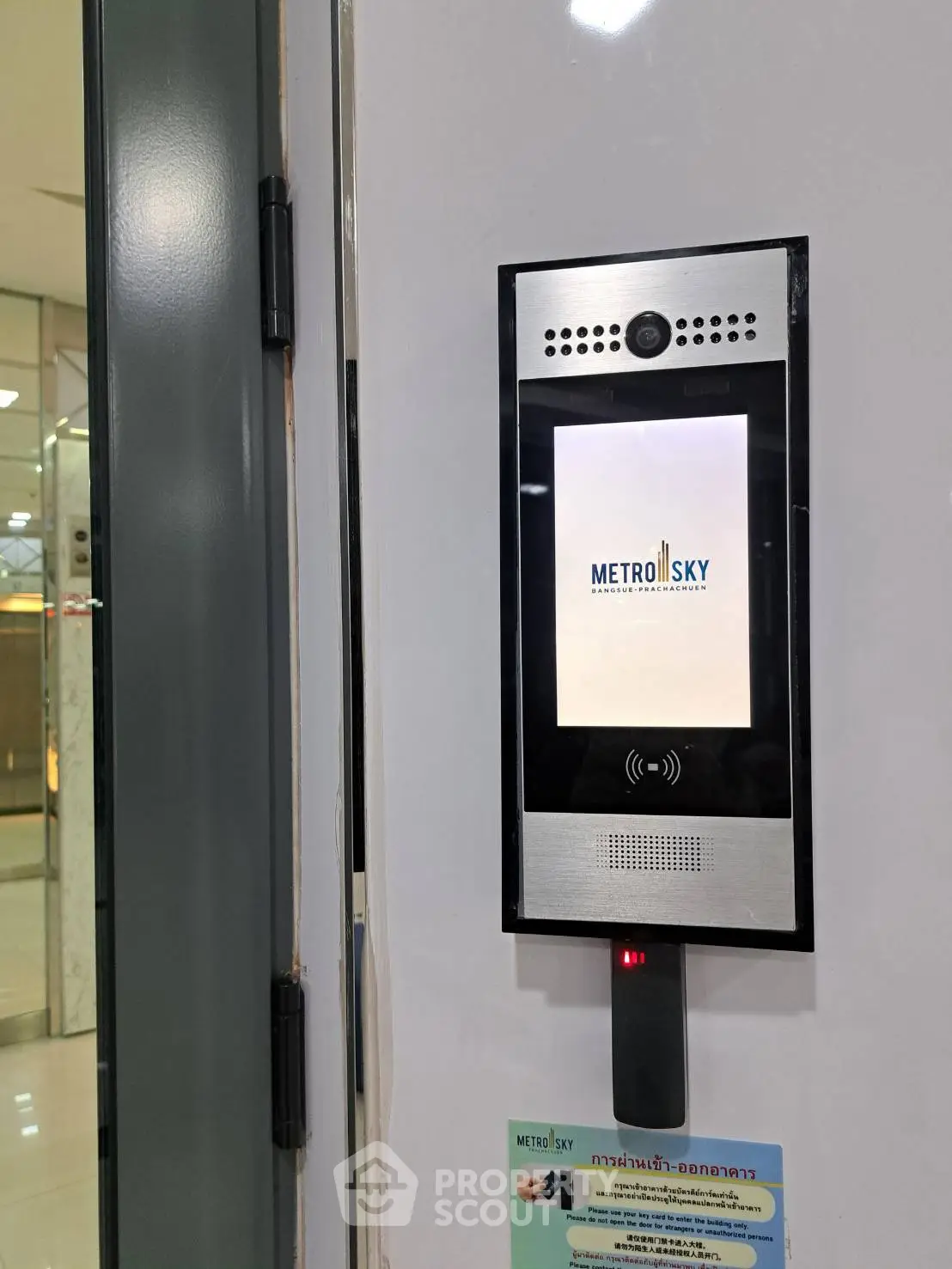 Modern building entrance with secure access system and sleek design.