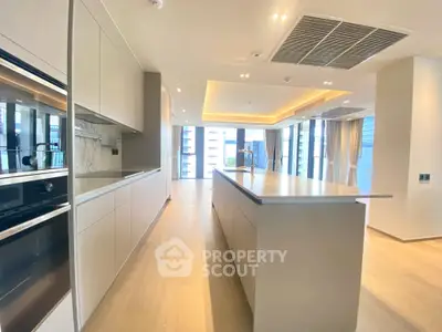 Luxurious modern kitchen with island and open layout in high-end apartment