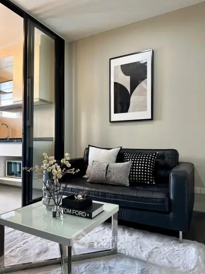 Stylish modern living room with black leather sofa and chic decor