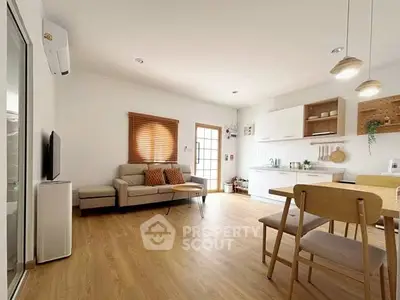 Spacious open-plan living room with modern kitchen and stylish decor