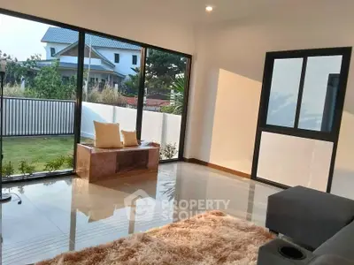 Spacious living room with large windows and garden view in modern home