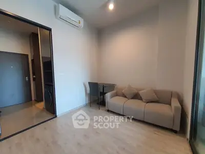 Modern living room with cozy sofa and dining area in a stylish apartment.