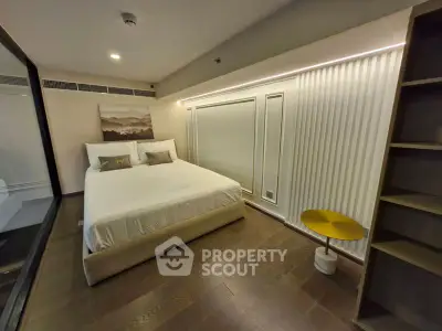 Modern bedroom with elegant decor and cozy lighting in a stylish apartment.