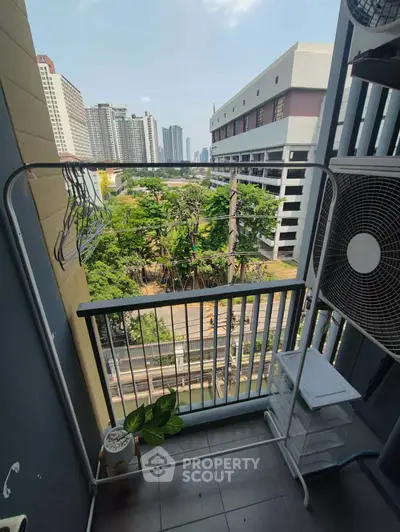Urban balcony with city view and air conditioning unit, ideal for compact living spaces.