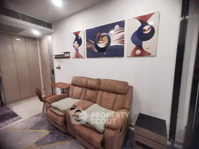 Modern living room with cozy recliner and abstract art decor