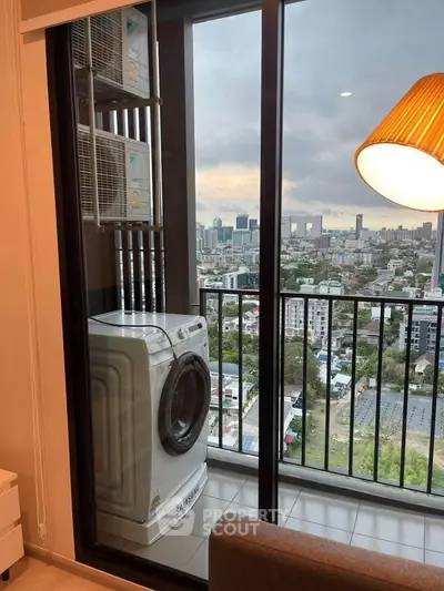 Modern apartment balcony with washing machine and city view, perfect for urban living.