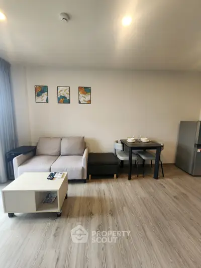 Modern living room with cozy sofa, dining table, and stylish decor in a bright apartment.