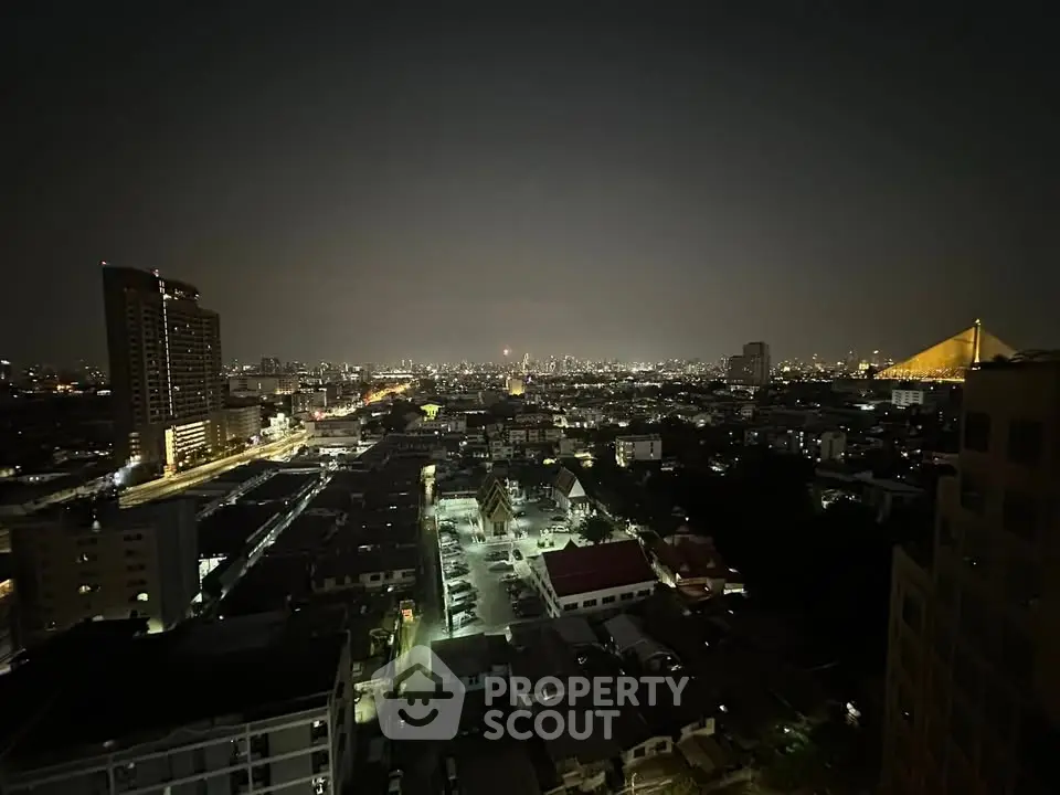 Stunning nighttime cityscape view from high-rise building balcony.
