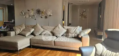 Luxurious living room with elegant decor and plush seating in modern apartment.