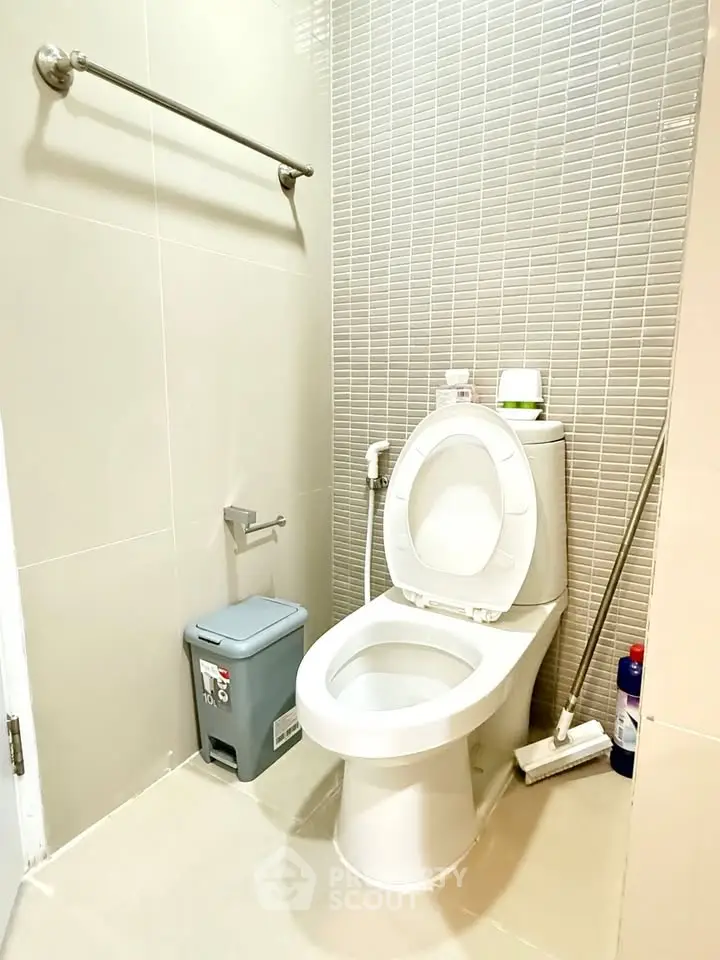 Modern bathroom with sleek design and essential amenities in a contemporary home.