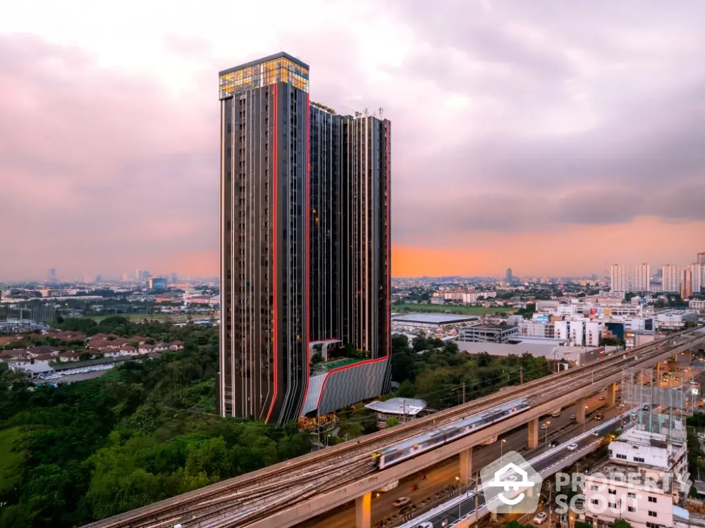 Stunning high-rise building with panoramic city views at sunset, ideal for urban living.