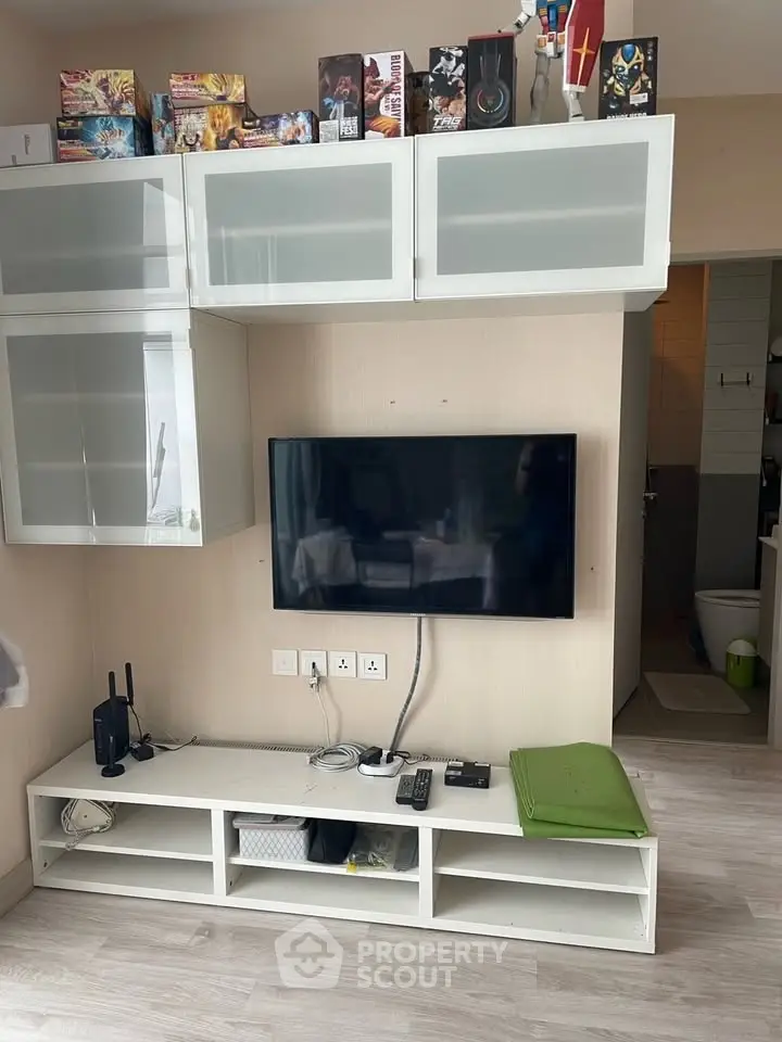 Modern living room with wall-mounted TV and sleek storage cabinets, perfect for urban living.