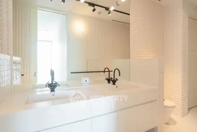 Modern bathroom with dual sinks and elegant white tile design