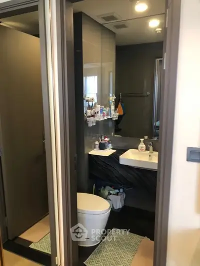 Modern bathroom with sleek design and contemporary fixtures in a stylish apartment.